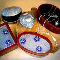Different styles of jewelry boxes and a couple of necklaces