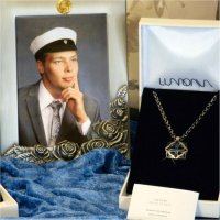 A couple of mens' necklaces and a graduation photo frame